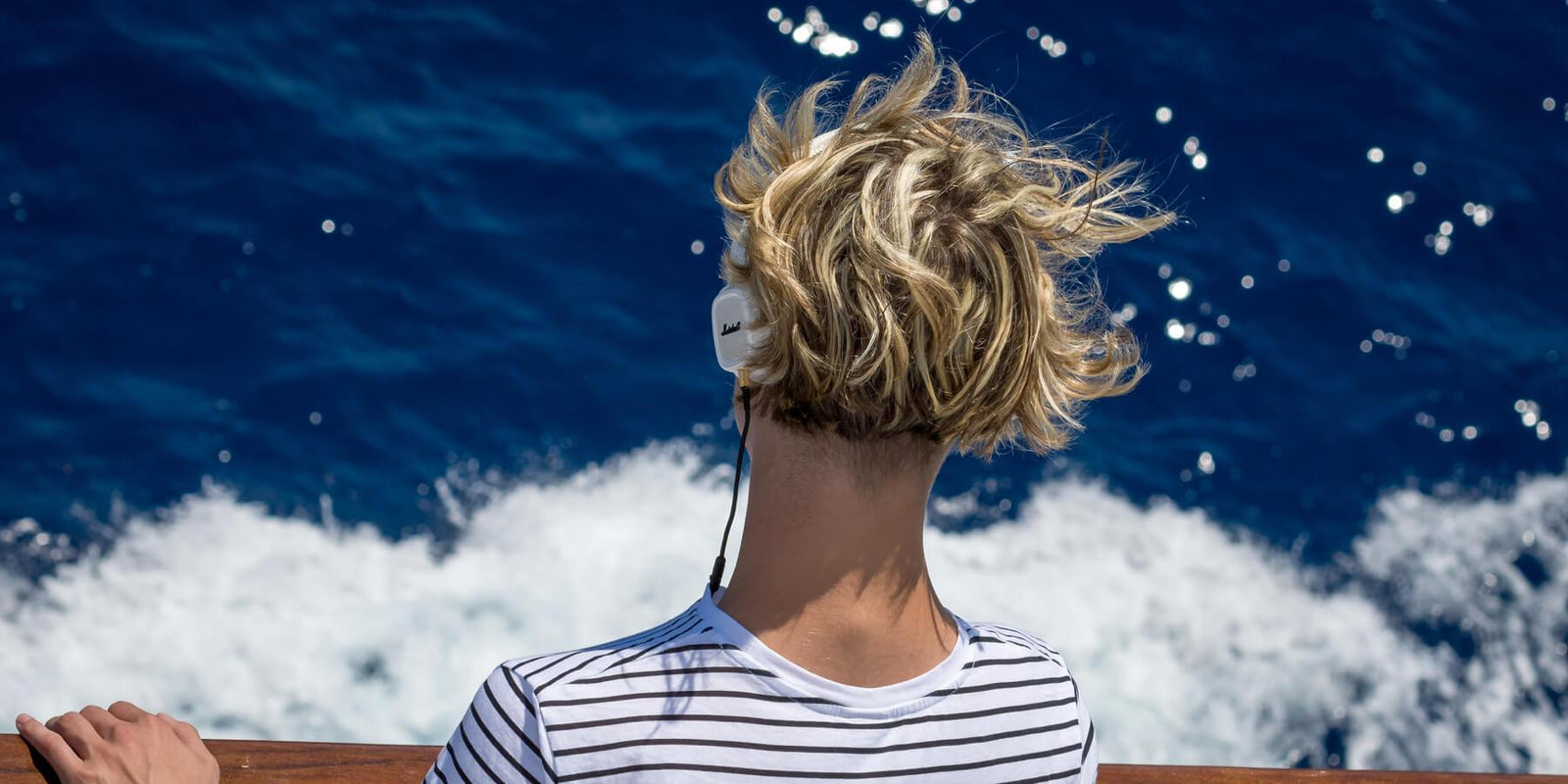 Woman enjoying the sea from the Gourmante Mediterranean Living Magazine